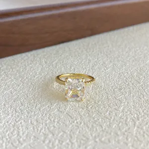 Detailed view of an emerald cut sparkling zircon ring with gold finish for weddings