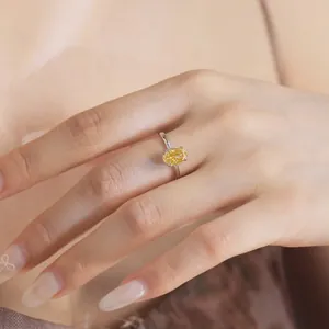 Close-up of elegant S925 sterling silver ring with sparkling yellow zircon on hand.