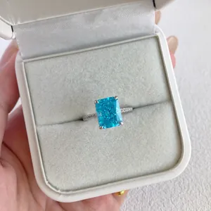 Close-up view of a sterling silver ring featuring a sparkling blue rectangular cut zircon stone