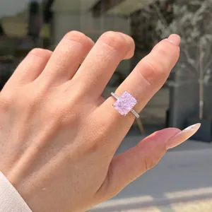 Close-up macro detail of an elegant pink cushion-cut zircon ring worn on a hand