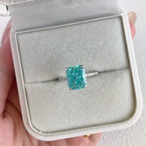 Close-up of S925 sterling silver ring with radiant cyan zircon in elegant white gift box