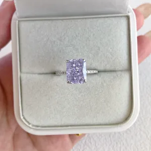 Macro detail of a lavender radiant-cut zircon ring presented in a white velvet jewelry box