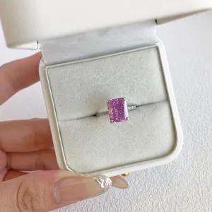 Close-up of radiant pink emerald cut zircon ring in a luxury white velvet jewelry box