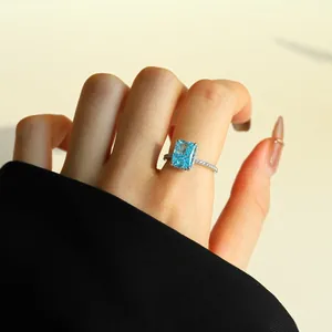 Close-up of ice flower cut blue zircon ring on finger, S925 sterling silver.