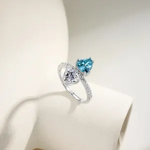 Close-up of S925 silver ring featuring blue and white heart-cut zirconia stones