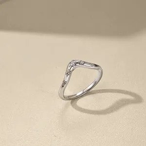 Detailed shot of a wavy S925 sterling silver ring accented with cubic zirconia.