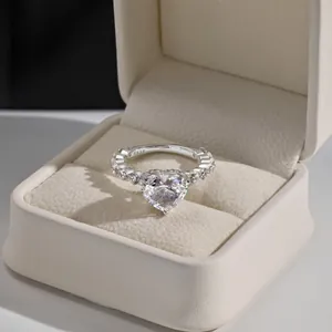 Macro view of an elegant heart-shaped cubic zirconia ring in a luxury beige jewelry box