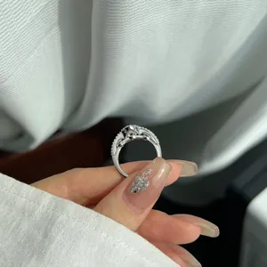 Close-up view of a silver heart ring band with pave-set shimmering stones.