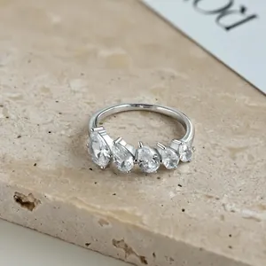 Macro view of a S925 sterling silver ring featuring five graduated pear-cut stones.