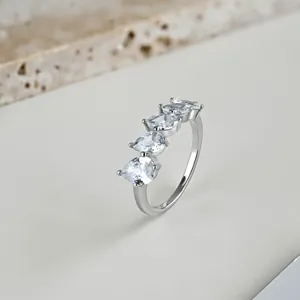 Detailed macro view of silver ring featuring four sparkling pear-shaped teardrop stones
