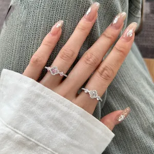 Detail shot of elegant S925 sterling silver rings with heart and clover zircon accents