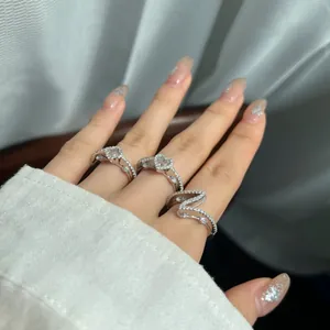 Close-up of three S925 sterling silver rings with heart and wavy cubic zirconia designs