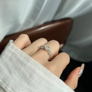 Detail view of a dainty S925 sterling silver four-leaf clover ring with sparkling cubic zirconia