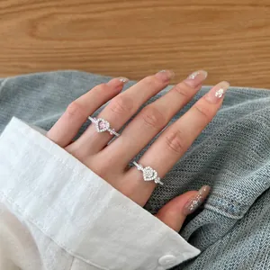 Detailed shot of S925 sterling silver heart rings featuring pink and white zircons