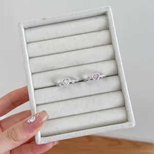 Detailed macro view of S925 sterling silver heart zircon rings in velvet jewelry box
