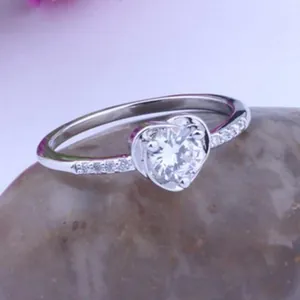 Elegant heart-shaped silver ring with sparkling AAA zircon stone on a natural prop