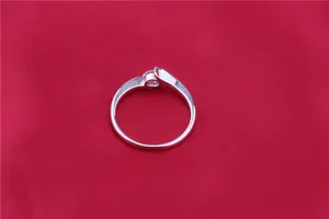 Elegant silver-toned bypass ring featuring a brilliant round-cut clear cubic zirconia stone