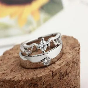 Detailed macro view of white gold plated zircon couple rings set on a natural cork base