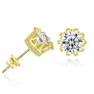 Close-up of gold crown-shaped stud earrings with brilliant round cut gemstone
