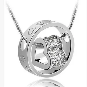 Close-up detail of silver rotating heart pendant necklace with sparkling Austrian crystals
