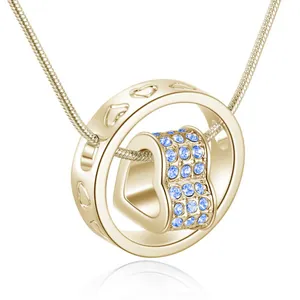 Close-up of gold-plated spinning heart necklace with light blue pavé crystals on snake chain