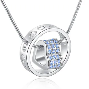 Detailed view of silver heart pendant featuring sparkling blue crystals on snake chain