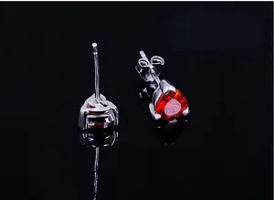 Detailed view of the heart-shaped red cubic zirconia stud earrings in a silver setting