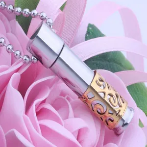 Close-up of stainless steel perfume bottle pendant with gold filigree detail