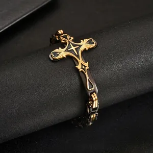 Detailed macro view of the ornate gold and black stainless steel cross bracelet element