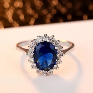 Elegant oval blue sapphire halo ring with zircon accents on a polished silver band