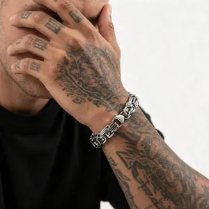Men's hip hop chunky stainless steel Byzantine chain bracelet on tattooed model wrist