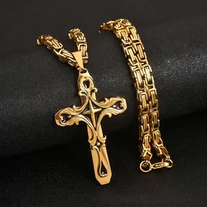 Detailed view of an ornate gold and black cross pendant with a thick Byzantine chain