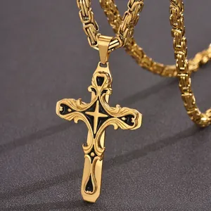 Close-up of a gold and black stainless steel hip-hop cross pendant with Byzantine chain.