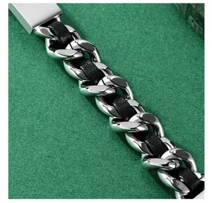 Detailansicht eines polierten Edelstahl-Cuban-Link-Armbands mit schwarzem Ledergeflecht
