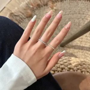 Model wearing two stacked S925 sterling silver eternity band rings on hand