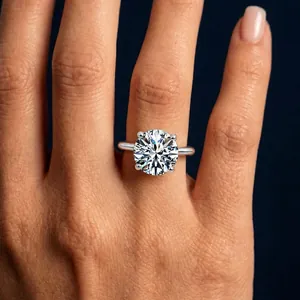 Close-up of a solitaire moissanite ring with a brilliant round cut in a silver four-prong setting
