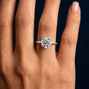 Close-up of a brilliant round-cut moissanite solitaire ring in a polished silver setting.