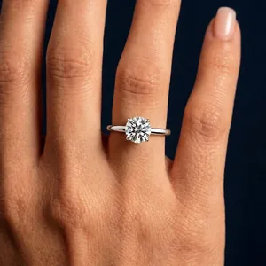 Close-up view of a brilliant moissanite solitaire ring worn on a finger for engagement