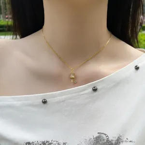 Detail of gold-plated S925 silver necklace with a delicate Tibetan prayer wheel pendant