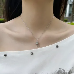Detailed shot of an elegant S925 sterling silver prayer wheel pendant necklace on a woman