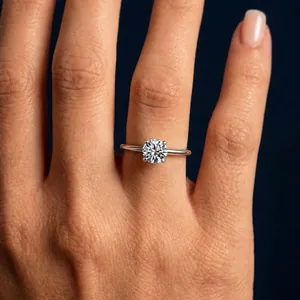 Close-up of a brilliant round cut Moissanite ring on a hand with a S925 silver band.