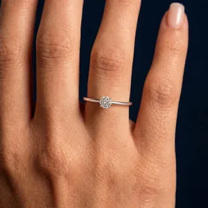 Detailed view of a brilliant round moissanite engagement ring in a four-claw setting