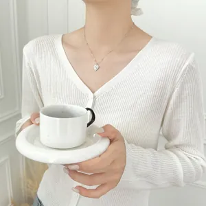 Elegant model wearing a textured S925 silver heart necklace for a graceful fashion look.