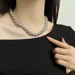 Close-up view of elegant S925 sterling silver bead necklace worn by a female model