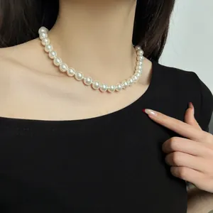 Close-up of an elegant white pearl necklace worn on an Asian model for fashion jewelry showcase