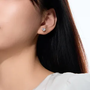 Gros plan d'une boucle d'oreille cœur en argent sterling portée par un mannequin