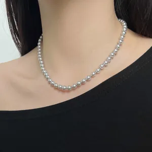 Detailed view of elegant grey S925 sterling silver pearl necklace on a model's neck.