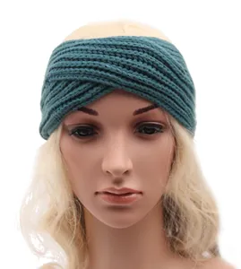Detail shot of a bohemian teal knitted cross headband for women on a mannequin