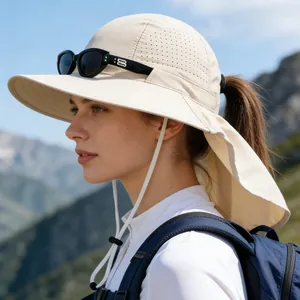 Detail view of the beige sun hat featuring a neck flap and ponytail hole on a model
