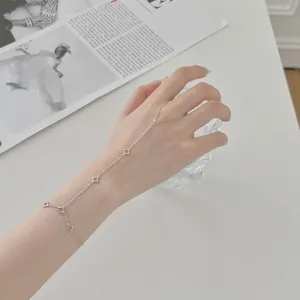 Vue détaillée d'un bracelet bague en argent S925 avec motifs trèfle portés sur une main